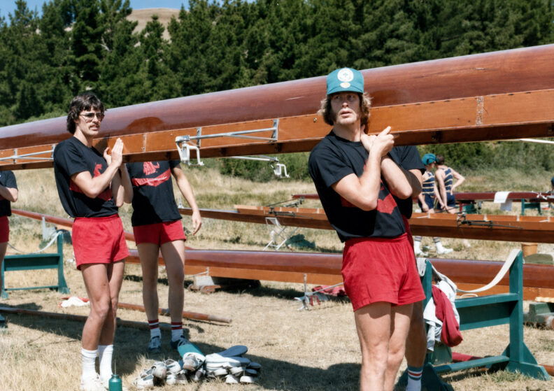 Brad Crollard, as a member of the Washington State University crew team, helps carry a rowing shell with teammates during a practice session.
