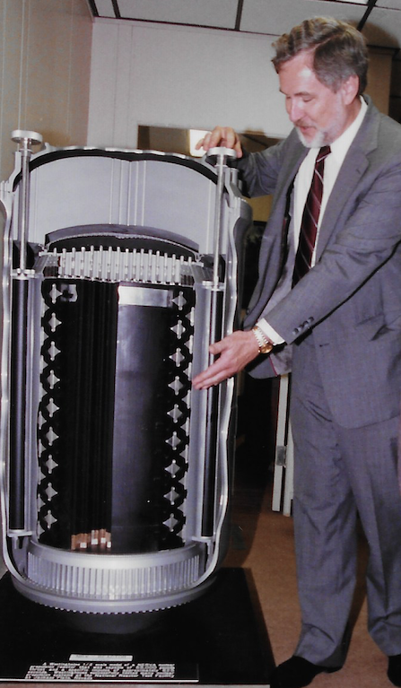 Circa the early 1990s, Gary Bennett points to a model of the reactor core for the Nuclear Engine for Rocket Vehicle Application reactor.