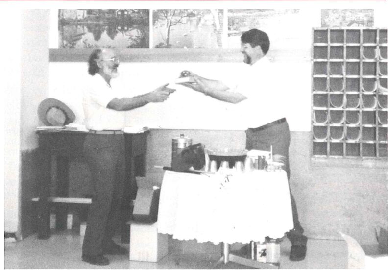 Former chair Royston Filby & new chair Roger Willett exchange gifts in 1992