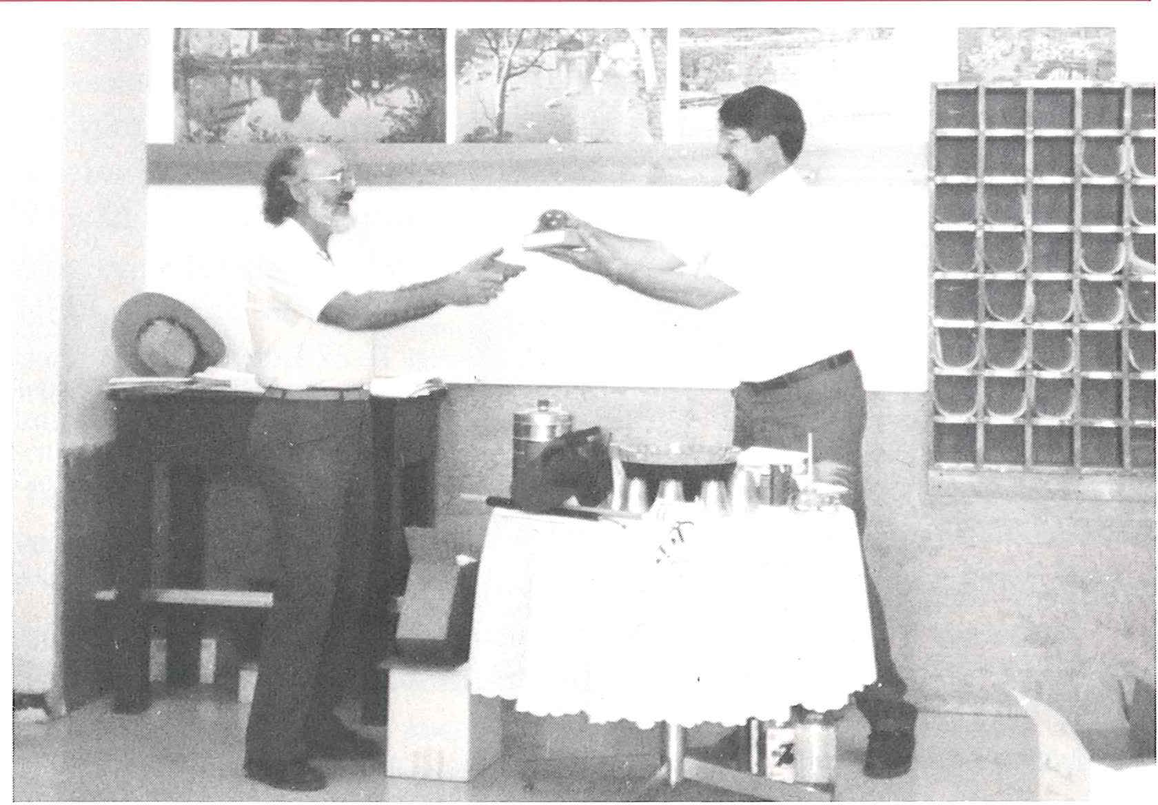 Former chair Royston Filby & new chair Roger Willett exchange gifts in 1992