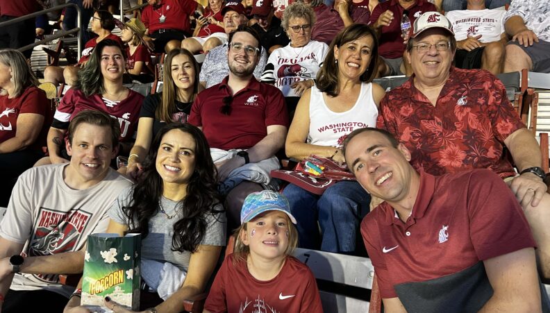 The Hawthorne family in WSU gear in the stands at a game