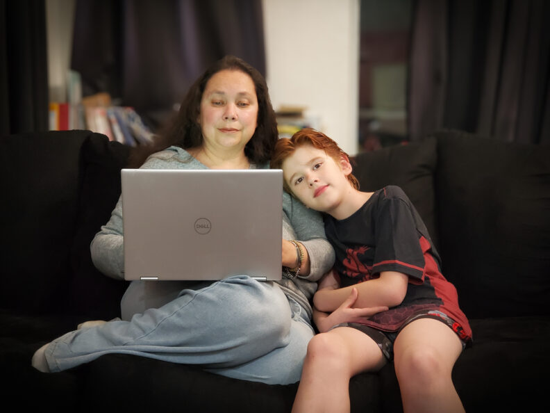 Anderson works on the computer alongside her son. 