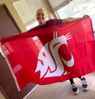 Andria holding a WSU flag