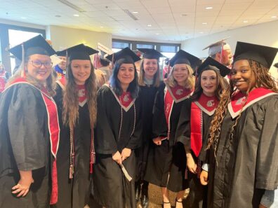Forsythe with human development graduates (left to right: Rhiana Carlson, Krista Wahlgren, Drew Haddix, Katie Forsythe, Kalyana Neville, TulaRose Jackson, Kiara Myers) at the 2026 Global Campus commencement