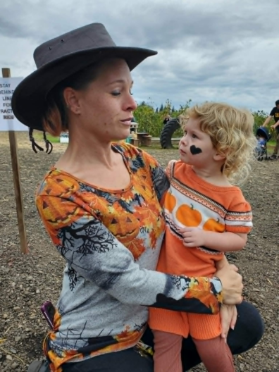 Elizabeth and her child at a pumpkin patch