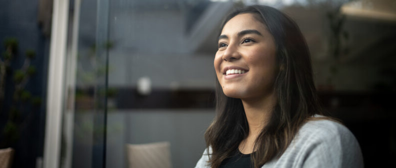 Smiling woman looking out window