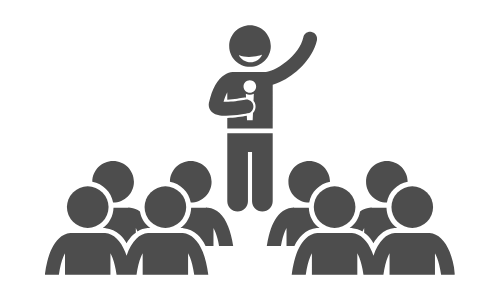 Icon of a person holding a microphone and speaking in front of an audience depicting student leadership.