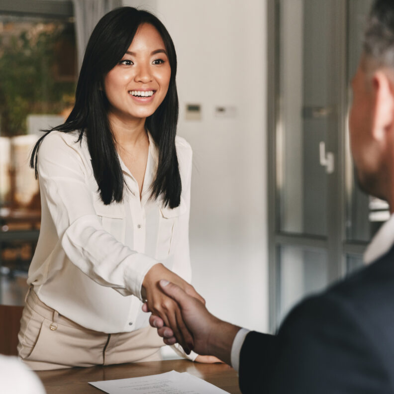 Woman shaking hands during job interview