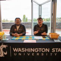 Untold Stories Event check in desk with two event staff members