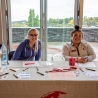 Untold Stories Event check in desk with two event staff members
