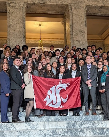 Example social media photo of crowd of people holding WSU flag. 