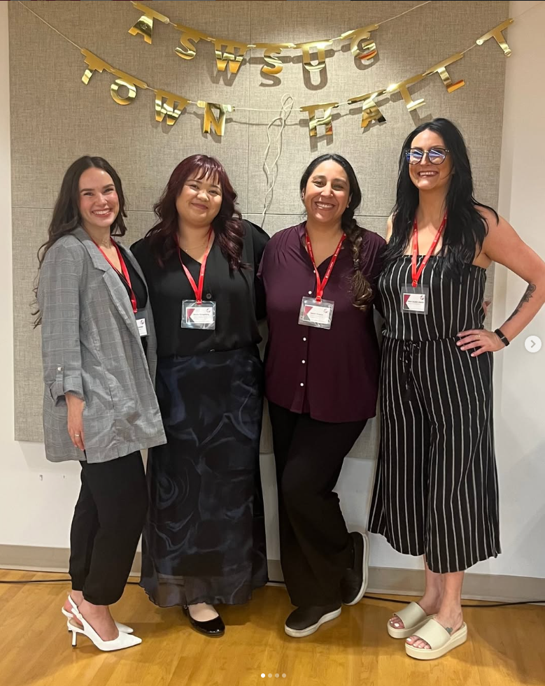 Example social media photo of four members of Global Campus student government standing in front of sign reading ASWSUG Town Hall. 