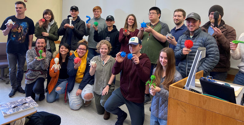 Photo: Students in General Virology class hold up their virus models created in the Spark Innovation Hub.