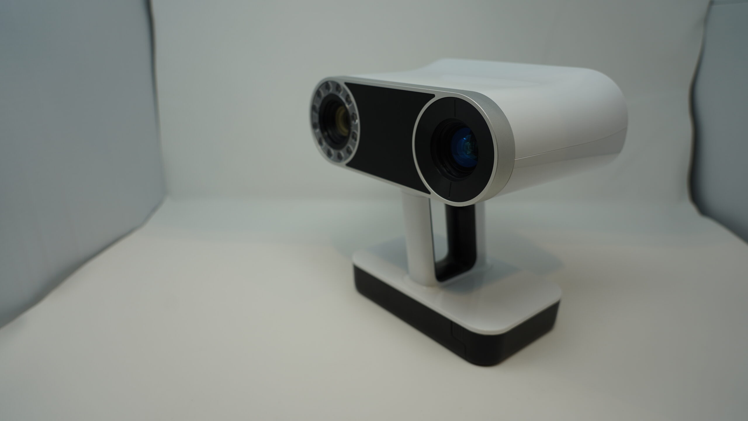 Handheld digital scanning tool. White plastic body with two capturing lenses.