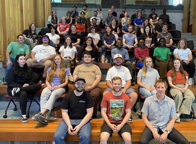 Group photo of th 2025-2026 trainees in a lecture hall.
