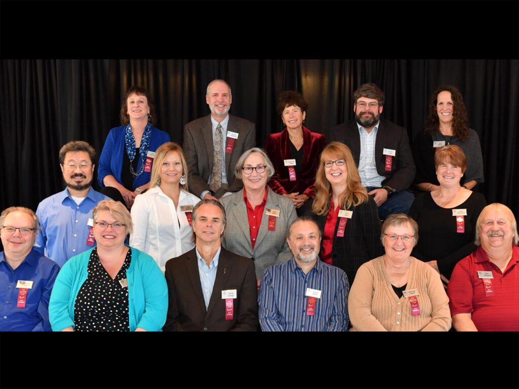 Three rows of smiling people.