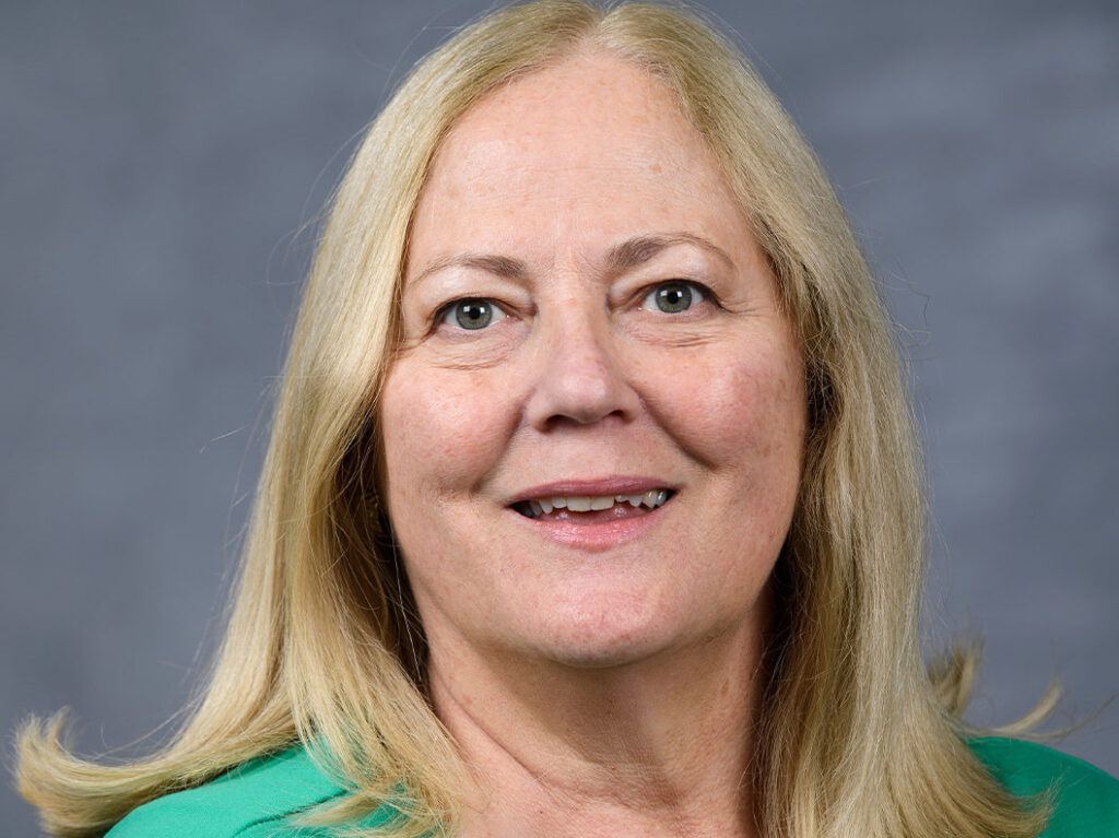 Closeup of a smiling woman with long hair.