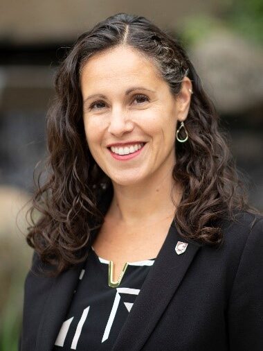 Professional portrait of a smiling woman.