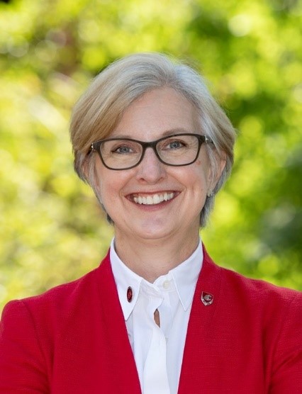Professional portrait of a smiling woman.