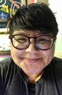Professional portrait of a smiling woman.