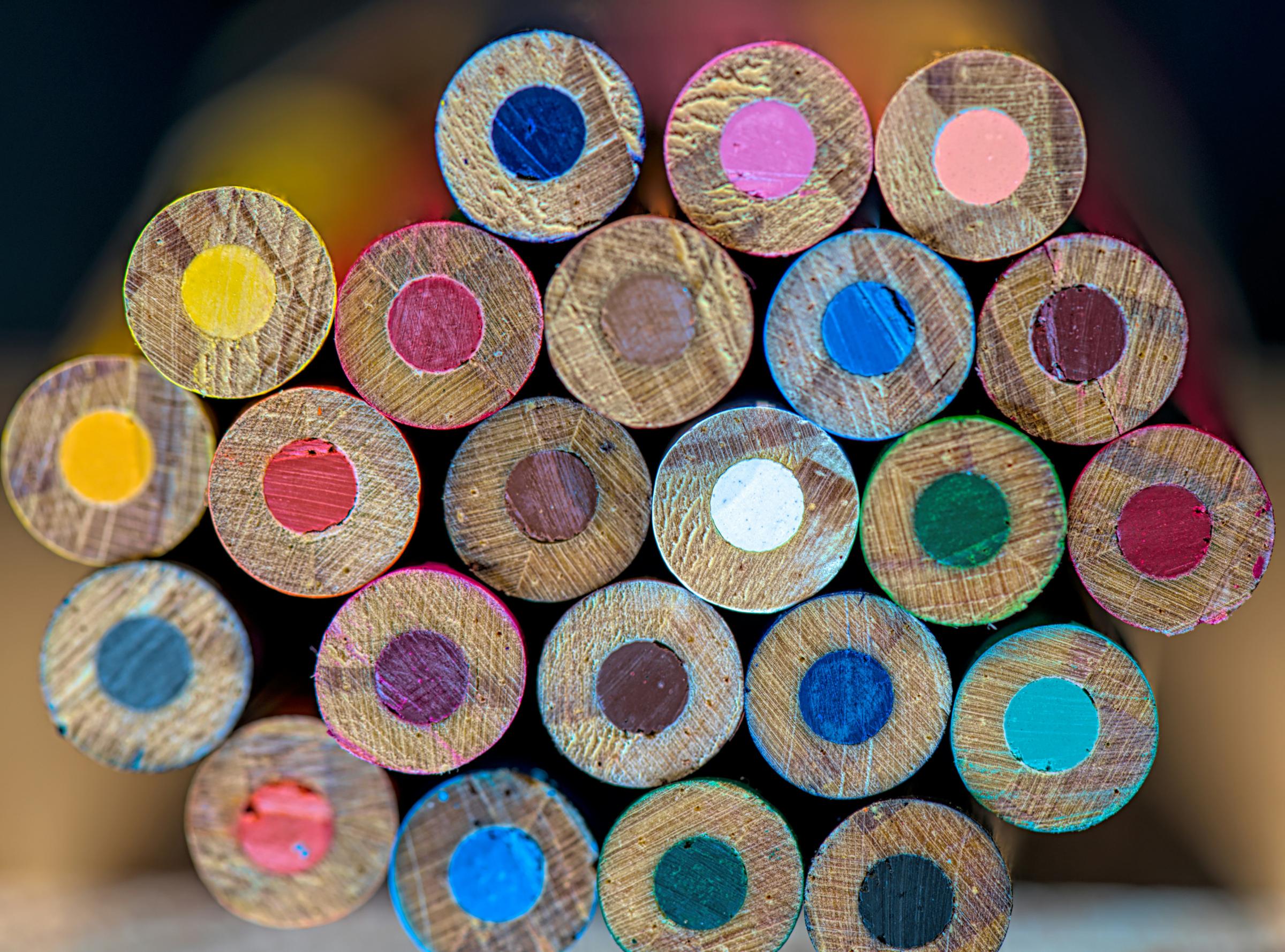 Close up of the bottoms of a bundle of colored pencils.