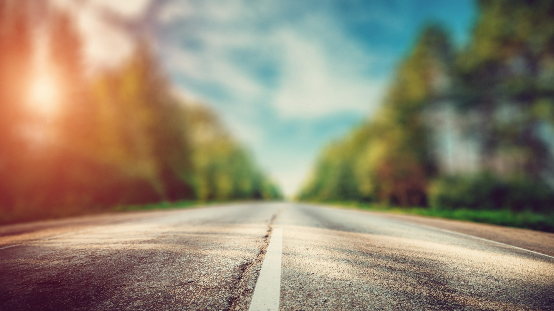Empty road leading toward the horizon with a center line guiding forward