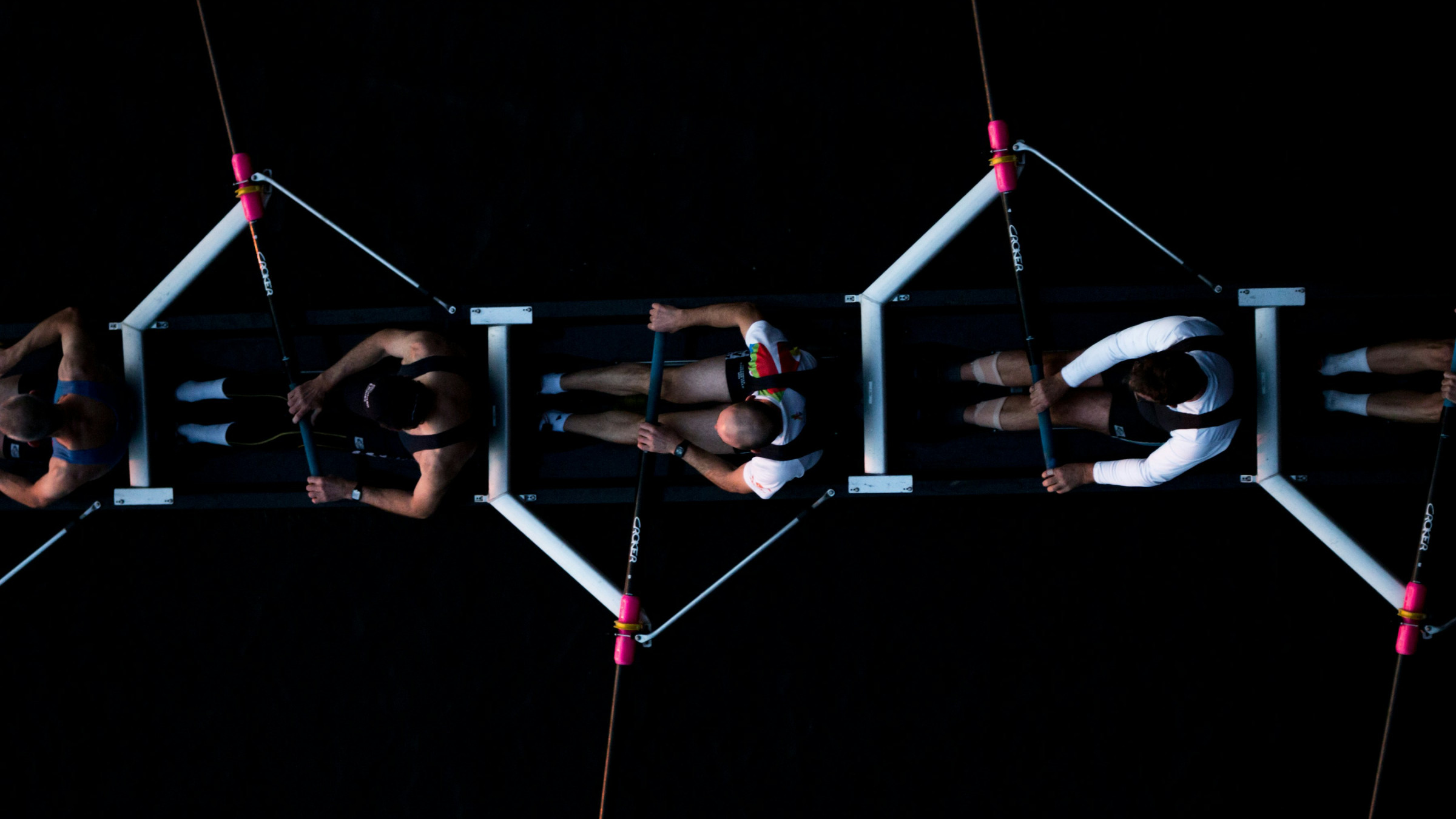 Overhead view of a row boat with 4 people.