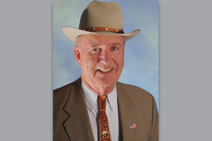 Dr. Horton in a suit and cowboy hat.