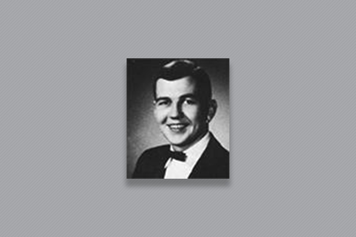 Robert in a black suit with a bow tie.