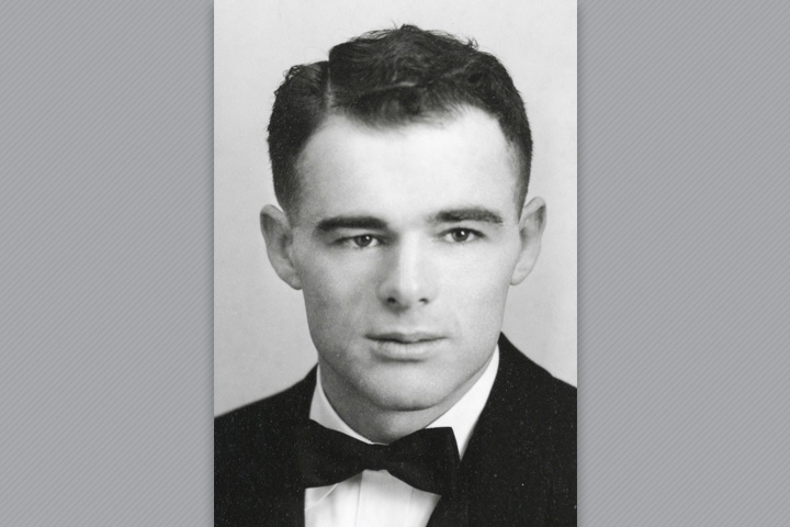 Melford, as a DVM student, wearing a suit and bow tie.