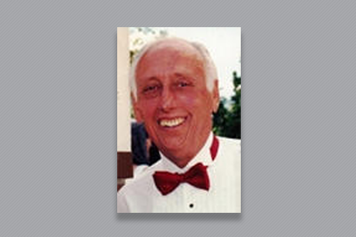 Dr. Dale in a tuxedo shirt with a crimson bow tie.