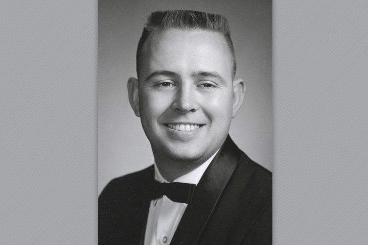Black and white photo of John in a suit with bow tie.
