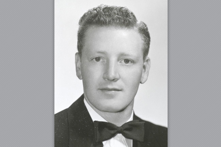 Robert as a student. He's wearing a suit with a bow tie.