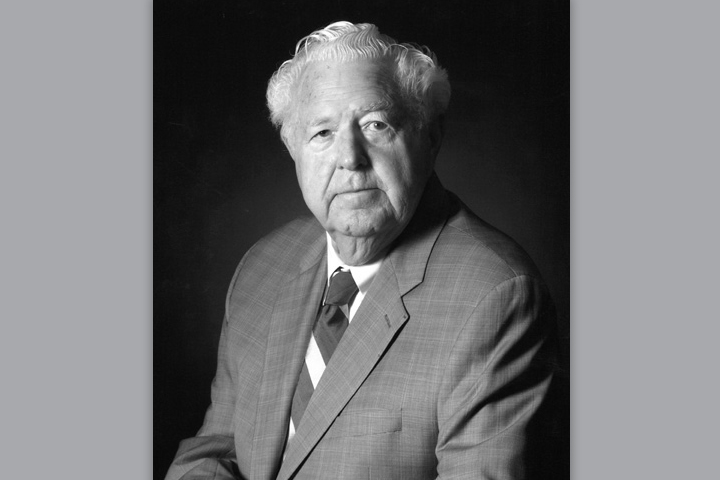 Andrew in a photo studio. He's wearing a suit and tie.