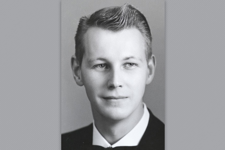 Black and white photo of John in a suit.