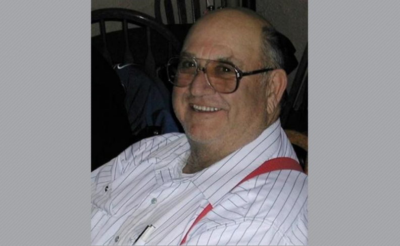 Photo of Robert Bell in white striped shirt with red suspenders