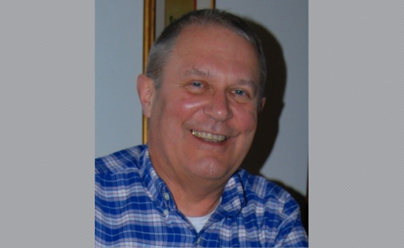 Headshot of John Cannon in blue plaid shirt.