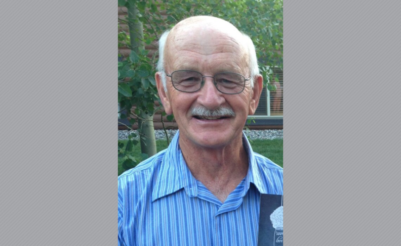 Gale Jellum wearing glasses in a blue striped shirt.