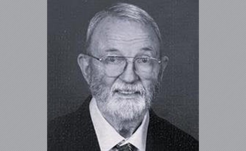 Black and white photo of Gary Johnston wearing glasses.