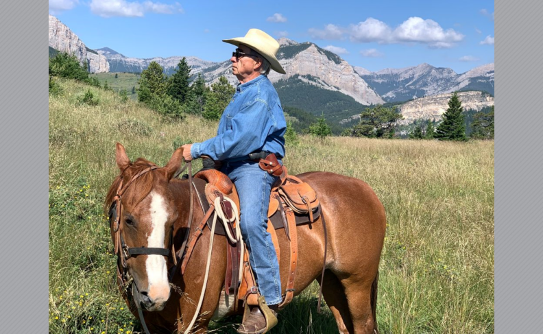 Robert Lee on horseback wearing cowboy hat.