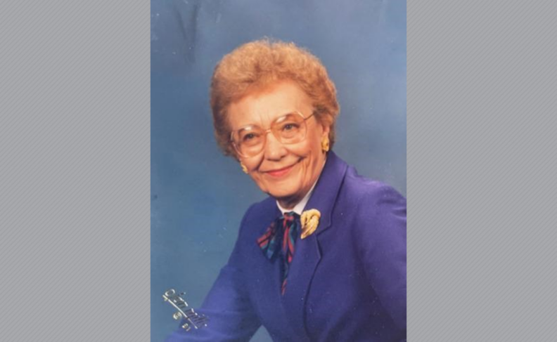 Virginia in a photo studio, wearing a purple blazer.