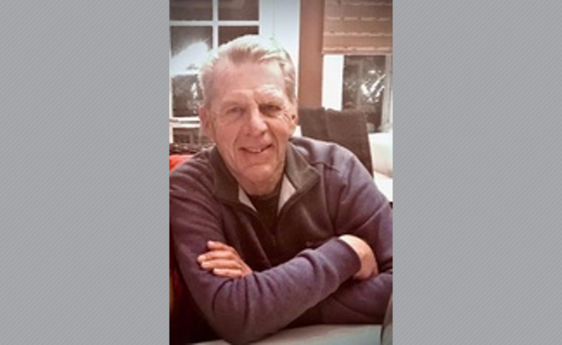 Leland Veith sitting with his arms crossed.