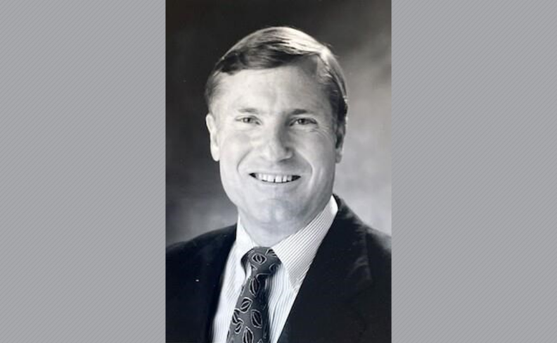 Black and white photo of Totten Warfield wearing a suit and tie.