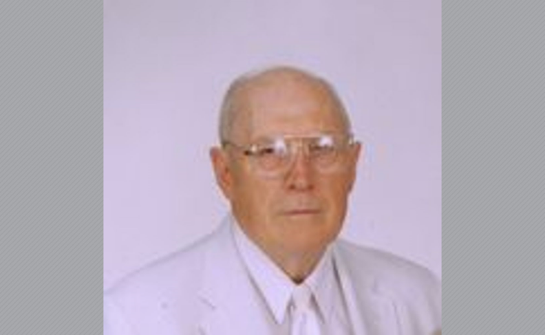 Photo of Cecil Watson in white suit and glasses.