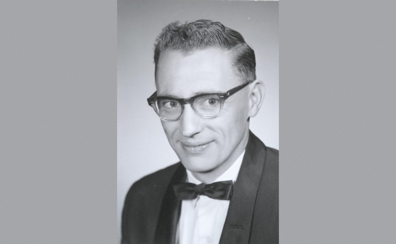 Black and white photo of Patrick Williams in glasses and a tuxedo.
