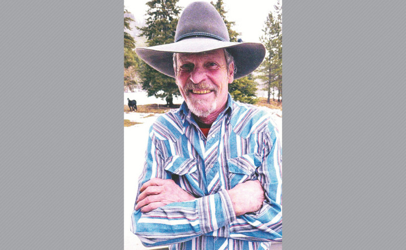 Photo of Duane Wolverton in cowboy hat and striped shirt.