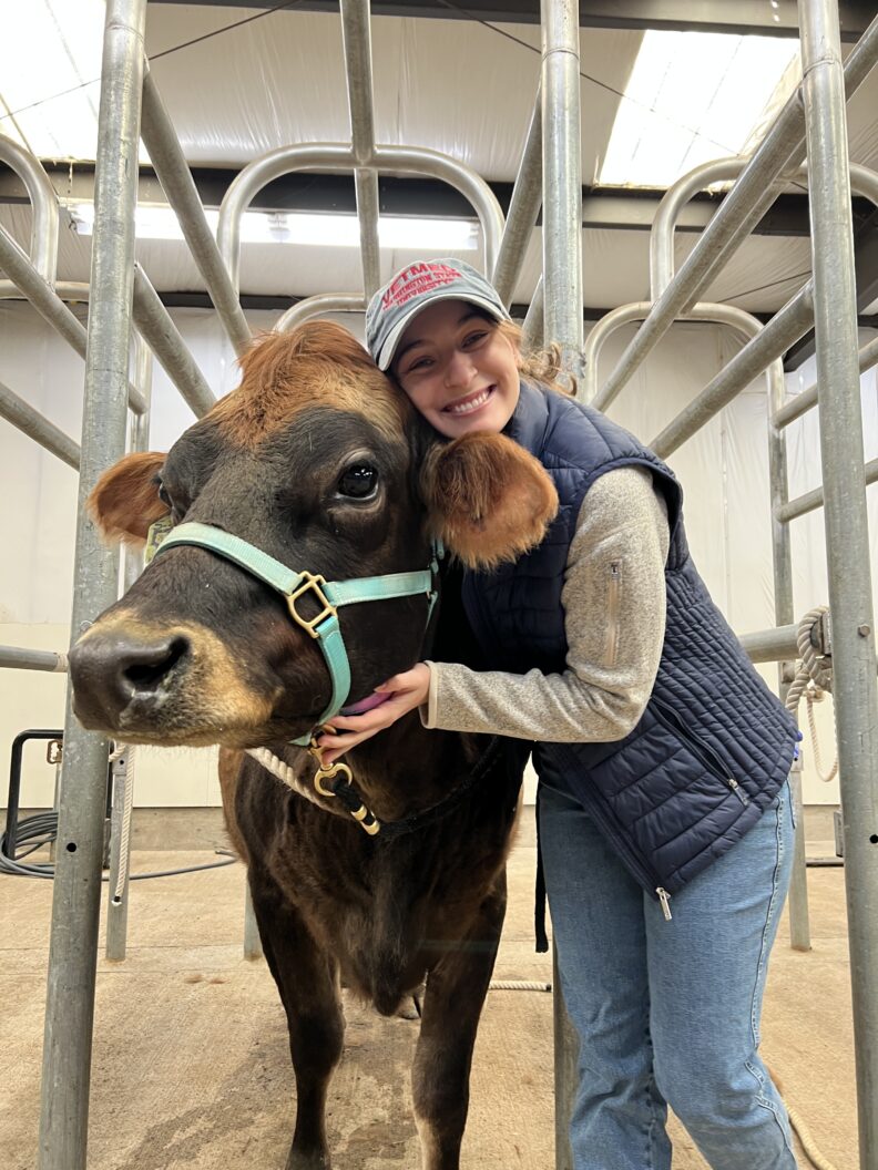 DVM student Brooklynn Balic stands with a cow