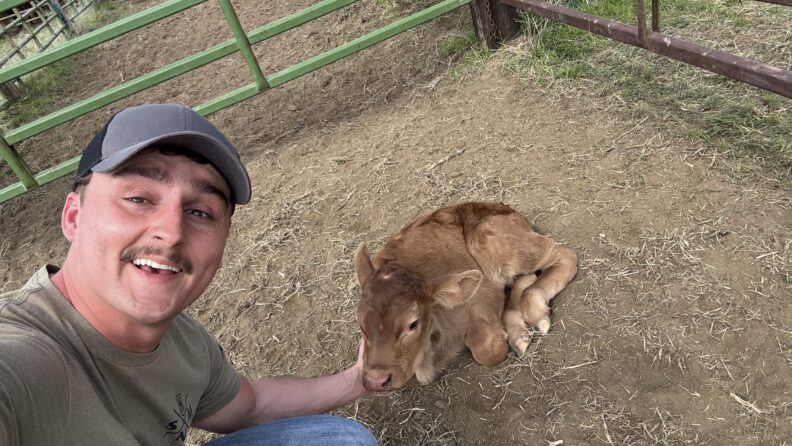 DVM student Brooklynn Balic stands with a cow