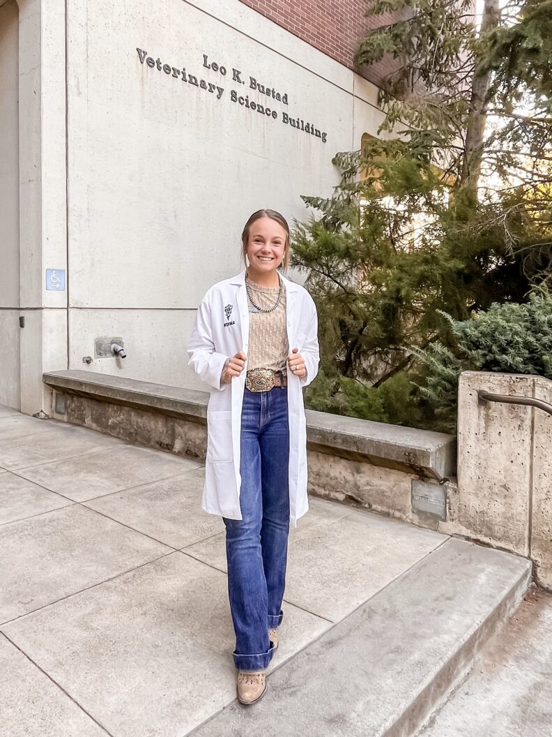 DVM student Brooklynn Balic stands with a cow