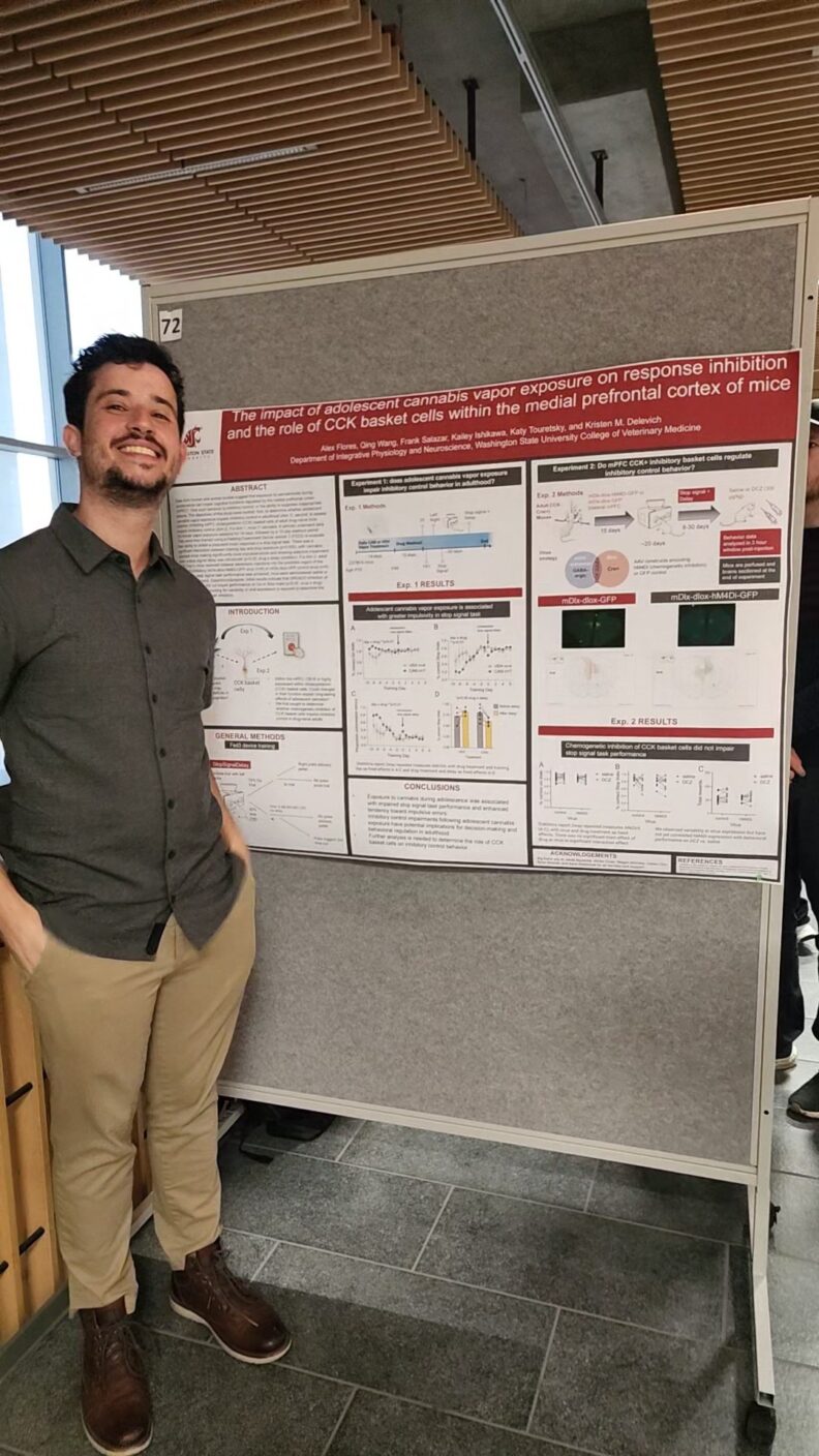 Alex Flores, DVM students stands in front of his research poster